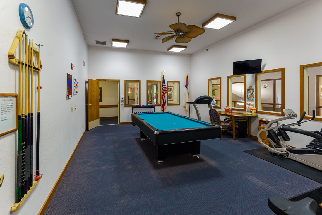 Ostego Place game room featuring a pool table and exercise equipment.